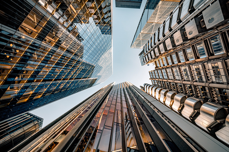Looking up to the sky while being surrounded by skyscrapers