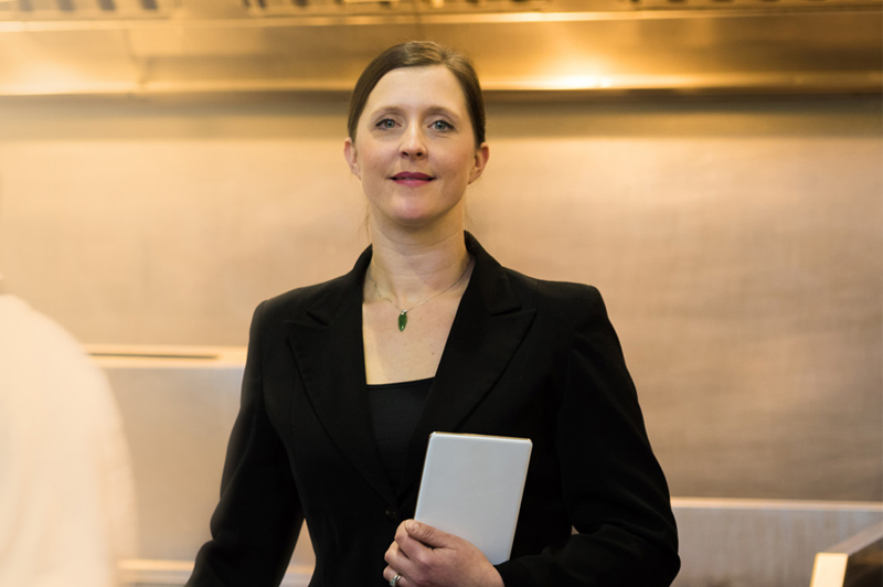 A business woman stares blankly into the camera