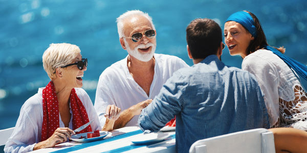 Wealthy couple talking to their kids over a meal.