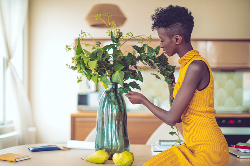 woman arranging flowers in vase