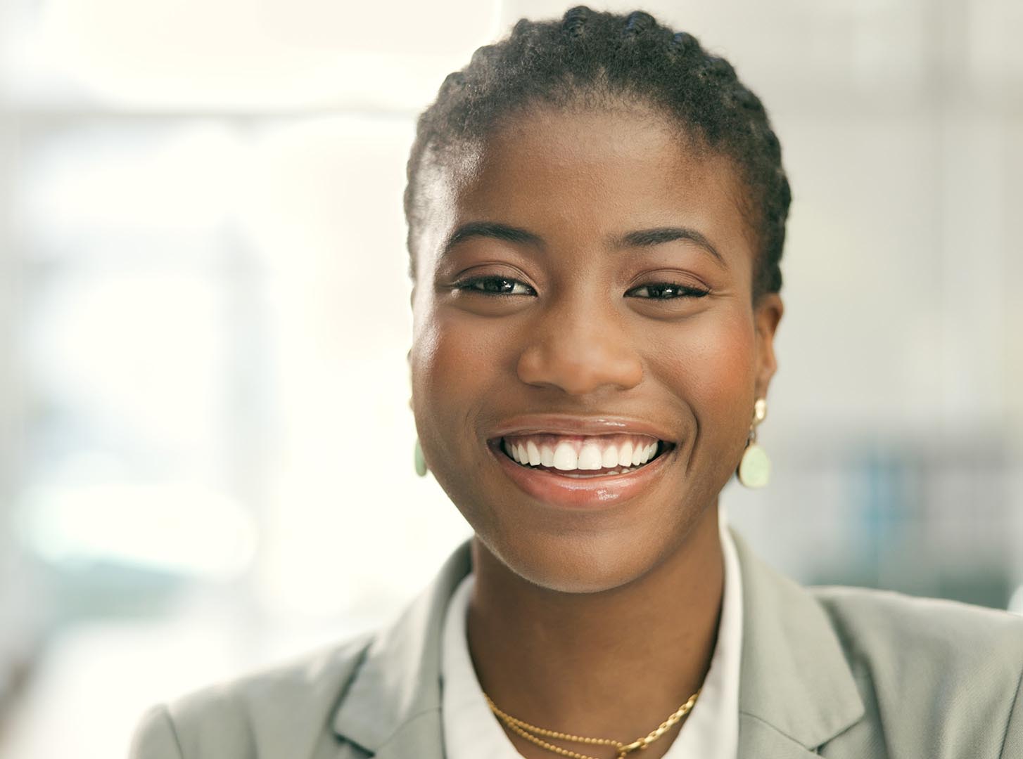 A business woman smiles directly into the camera