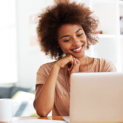 Woman smiling looking at computer