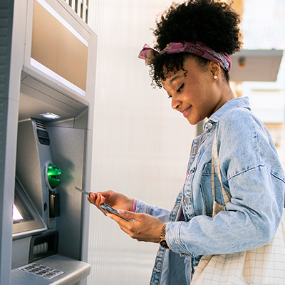 Woman getting cash out of the ATM