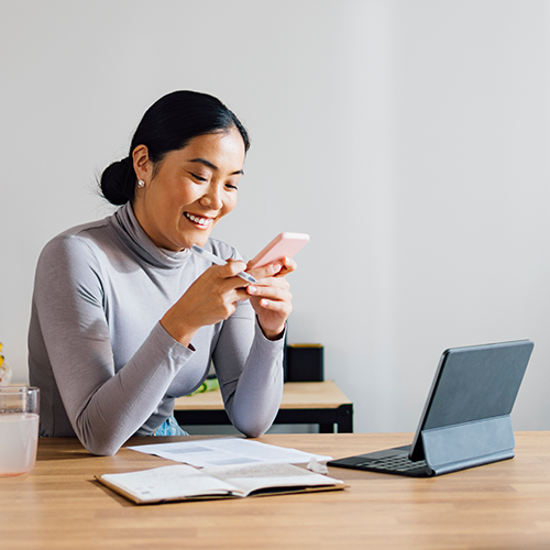 Woman smiling at her phone