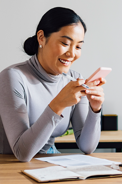 Woman smiling at her phone