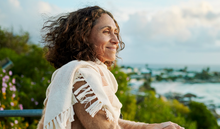 A red haired woman speaks to a man with glasses